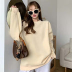 woman wearing light cream loose pullover with round collar and long sleeves Korean streetwear style
