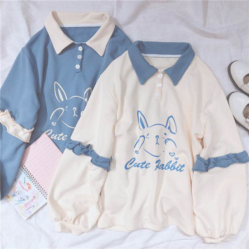 Women's oversized sweater with cute rabbit print and ruffled sleeves in blue and cream colors
