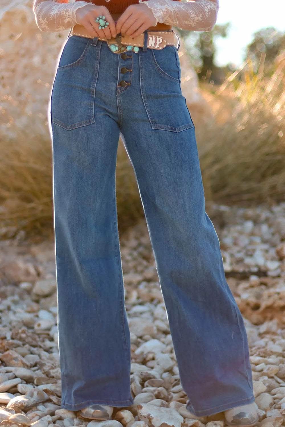 Woman wearing Ashleigh Blue Multi Buttons high waist wide leg jeans with front pockets outdoors