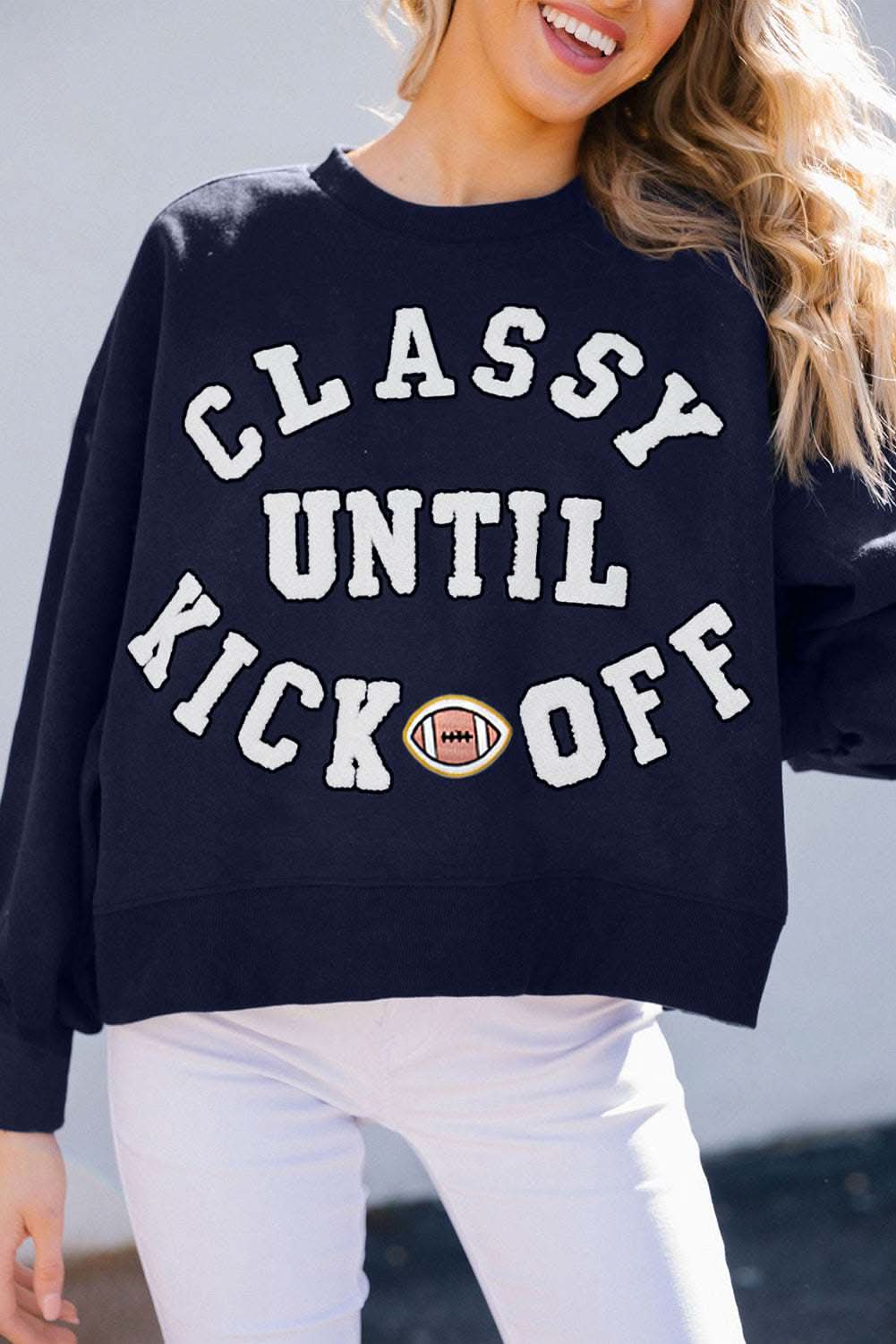 Navy blue oversized sweatshirt with plush "Classy Until Kickoff" lettering and football patch, cozy casual fit for fall and winter.