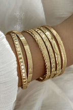 Gold 7pcs/set textured plated open alloy bangle set on wrist