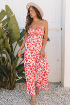 Woman wearing pink floral print twisted bandeau keyhole pleated wide leg jumpsuit with hat outdoors