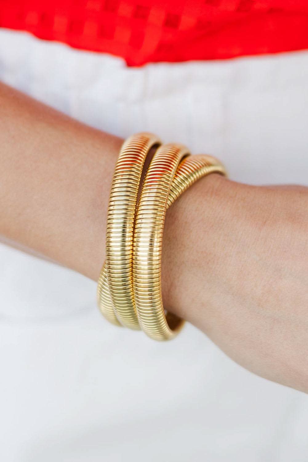 Gold 3 layers plated chunky alloy bangle on wrist