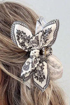 Black paisley floral print bow knot hair clip on blonde hair