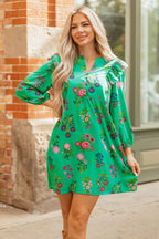 Woman wearing green floral ruffled three quarter sleeve buttoned mini dress outdoors