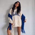 PrintedPlush hooded sweatshirt in cream with BALANCE print and blue scarf accessory worn by woman