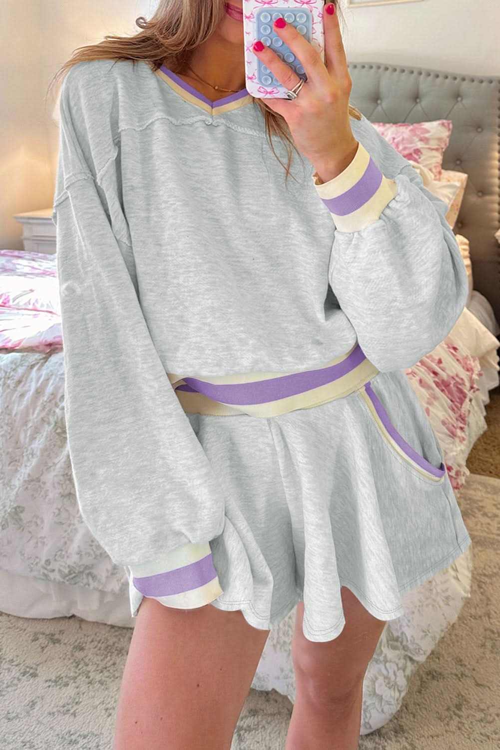 Light grey cropped pullover and athletic shorts set with purple and cream contrast striped bands