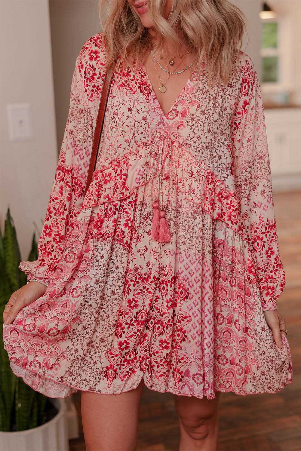Pink bohemian floral print long sleeve flowy mini dress with tassel tie detail