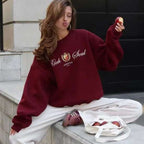 Woman wearing wine red fashion printing round-neck pullover with long sleeves and text design