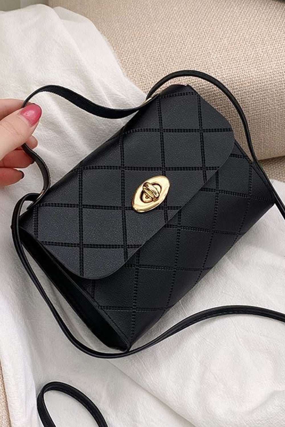 Black PU leather diamond pattern messenger bag with gold clasp and adjustable strap