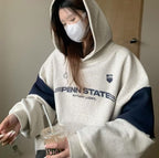 Women wearing gray and navy thick cotton autumn hooded pullover with letters and logo design