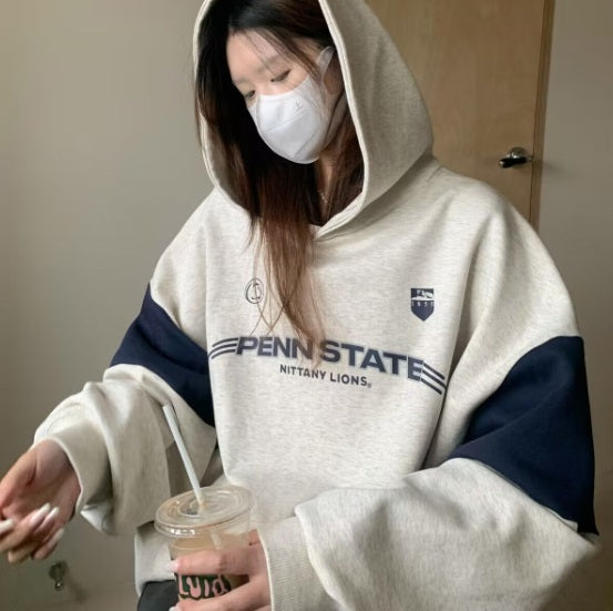 Women wearing gray and navy thick cotton autumn hooded pullover with letters and logo design