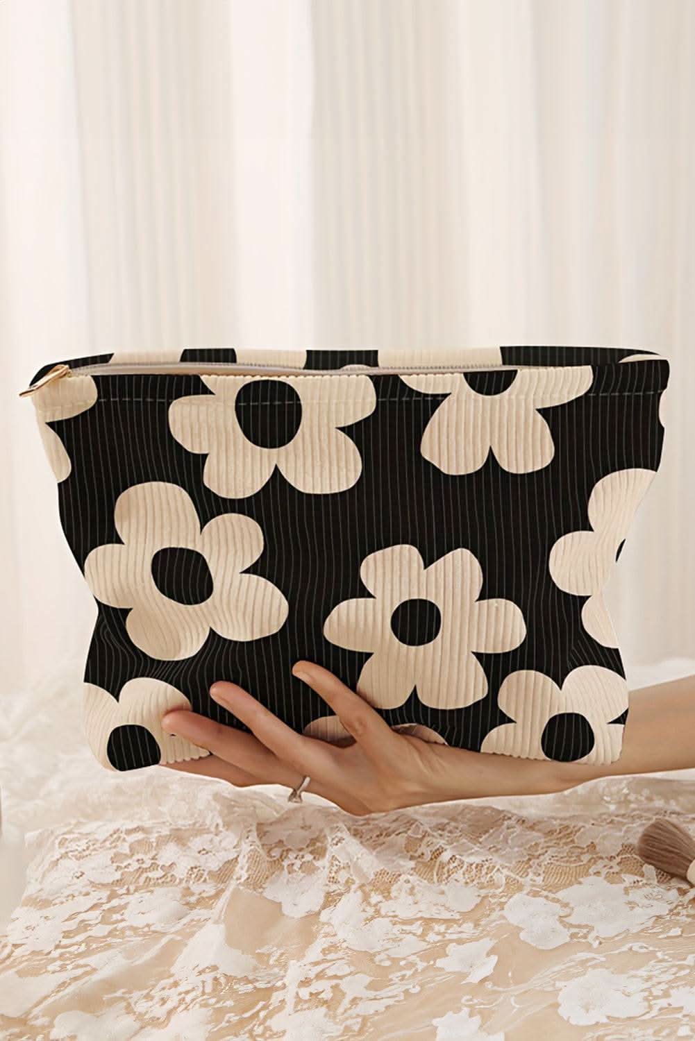 Black flower printed rib textured cosmetic bag with zipper closure and compact travel size