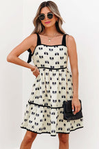 White bow knot print mini dress with knotted shoulder straps and contrast trim