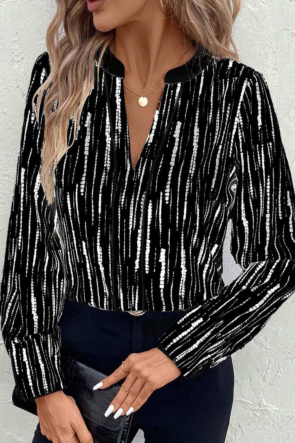 Black abstract printed V-neck blouse with cuffed long sleeves and sleek lightweight fabric