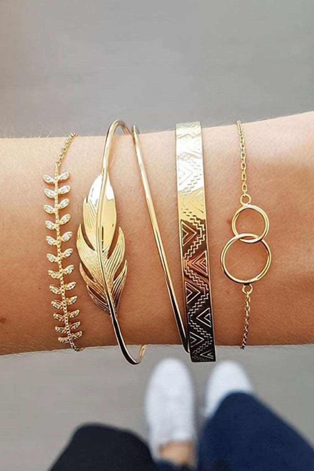 Set of five gold leaves retro pattern adjustable plated bracelets on wrist