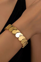 Gold Water Drop plated titanium steel bangle on wrist