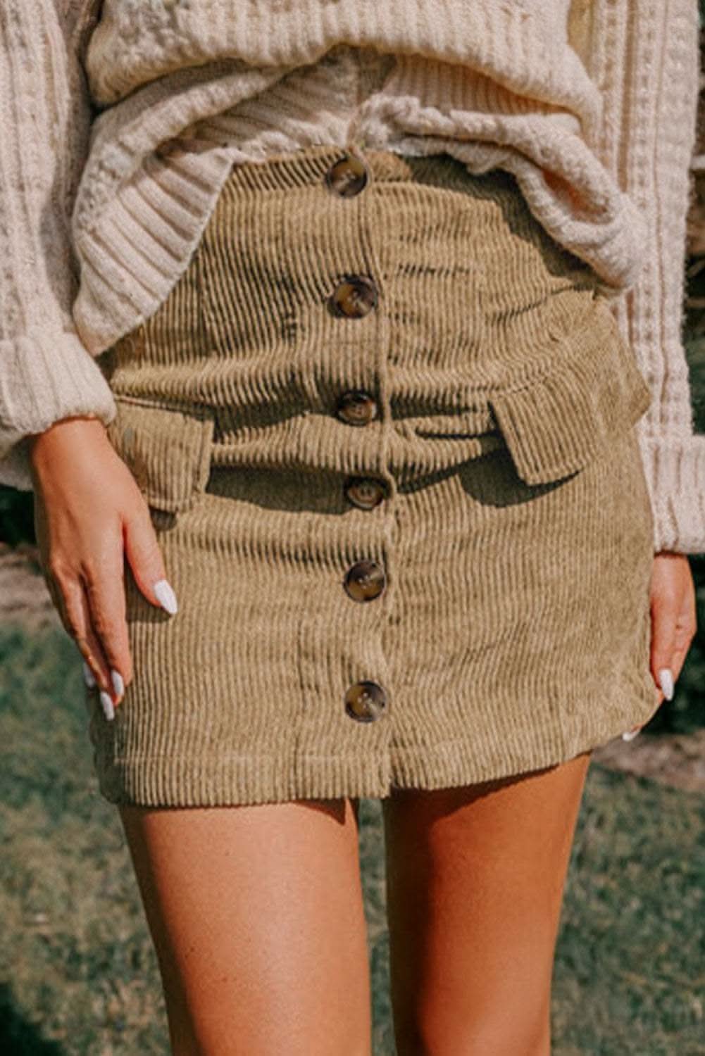 Camel corduroy mini skirt with buttoned front and faux pockets, vintage textured fabric.