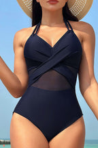 Navy blue halter one-piece swimsuit with mesh insert and cross front design