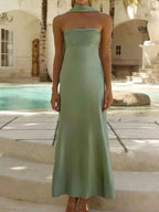 Sleeveless green Tube Mermaid Maxi Dress with fitted bodice and floor-length skirt by poolside